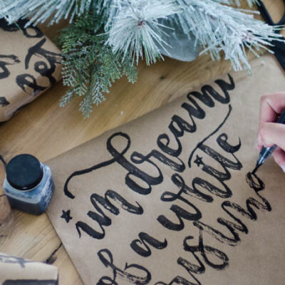 This handlettered Kraft wrapping paper is amazing! Now I want that brush so I can make some to wrap my christmas gifts