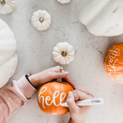 hand lettering with paint marker on pumpkins